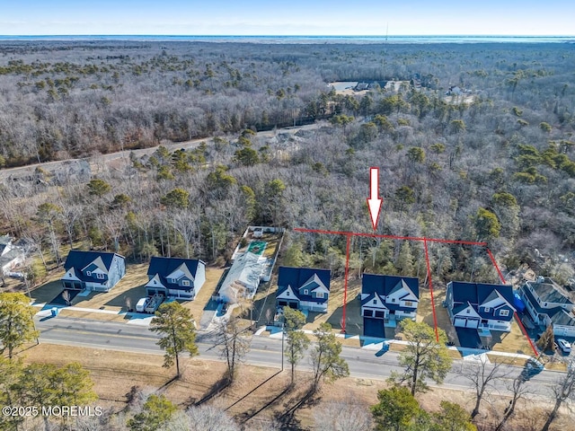 birds eye view of property with a view of trees