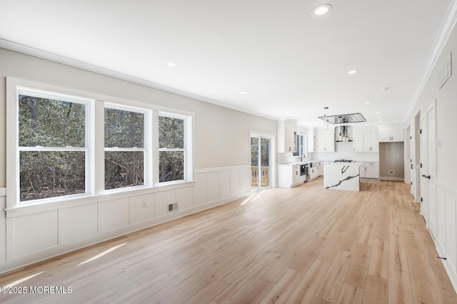 unfurnished living room with ornamental molding, recessed lighting, visible vents, and light wood finished floors