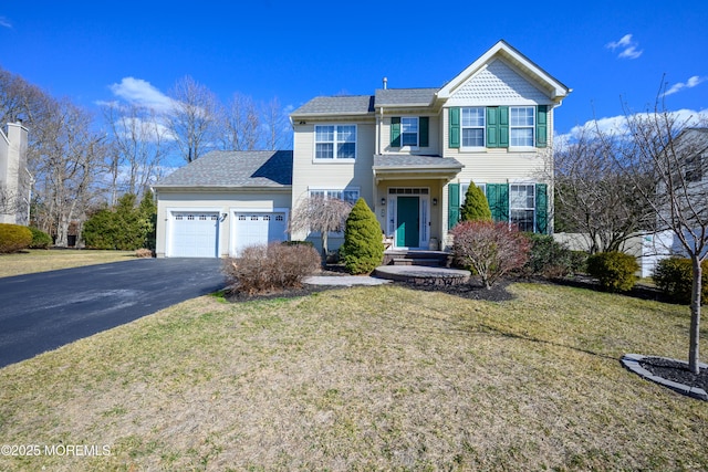 view of front of home with a garage, a front lawn, and aphalt driveway