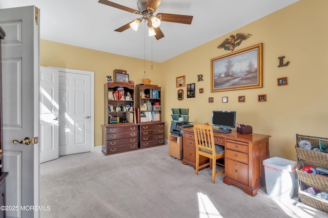 carpeted office space with ceiling fan