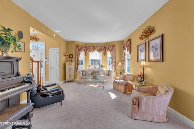 living area featuring carpet floors and baseboards