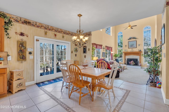 dining area with a healthy amount of sunlight, light tile patterned floors, and a fireplace