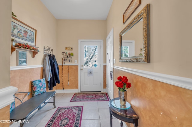 entryway featuring a wainscoted wall and tile patterned floors