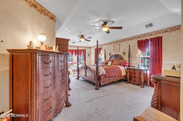 bedroom with vaulted ceiling, multiple windows, carpet, and visible vents