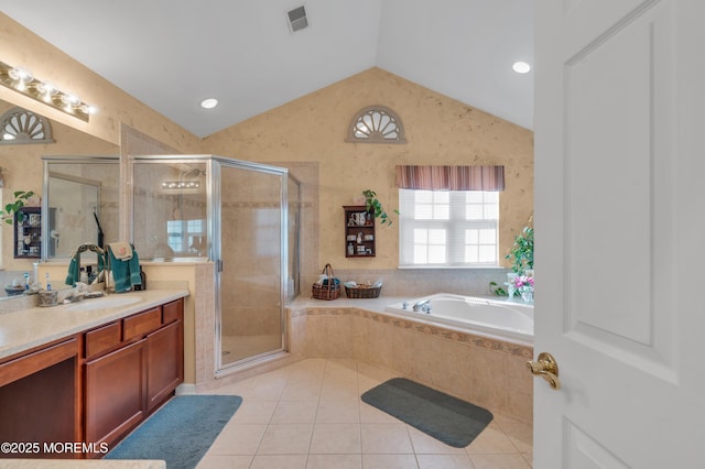 bathroom with a stall shower, tile patterned floors, a garden tub, vaulted ceiling, and vanity