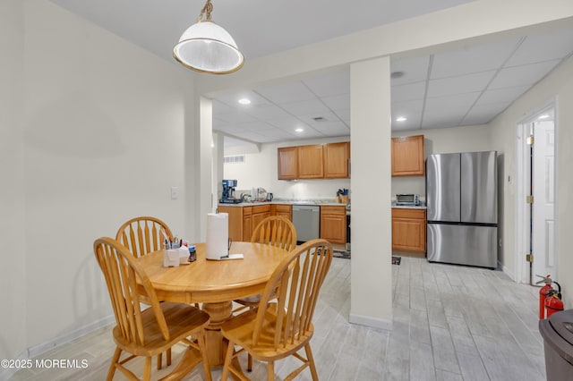 dining room featuring visible vents, baseboards, wood finish floors, a paneled ceiling, and recessed lighting