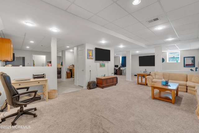 carpeted living area with washer / dryer, visible vents, and a drop ceiling