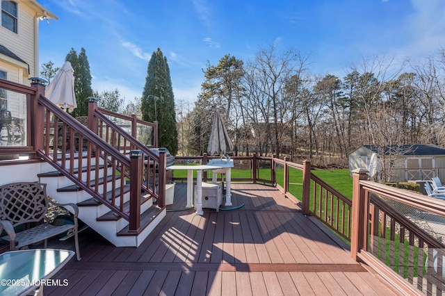 deck featuring an outbuilding, a yard, and a storage shed