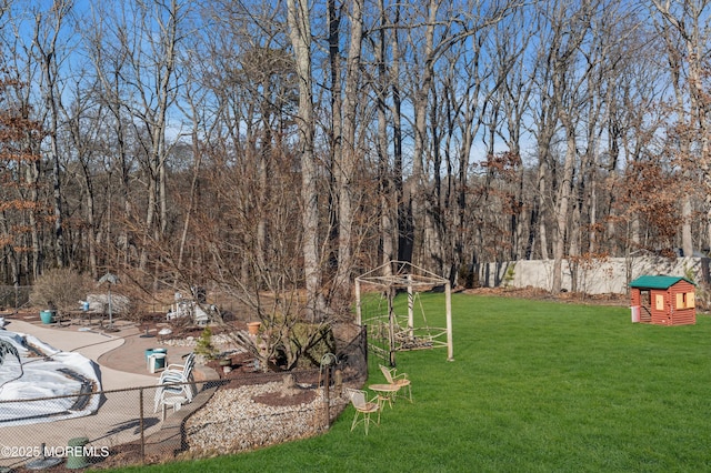 view of yard with fence and a fenced in pool