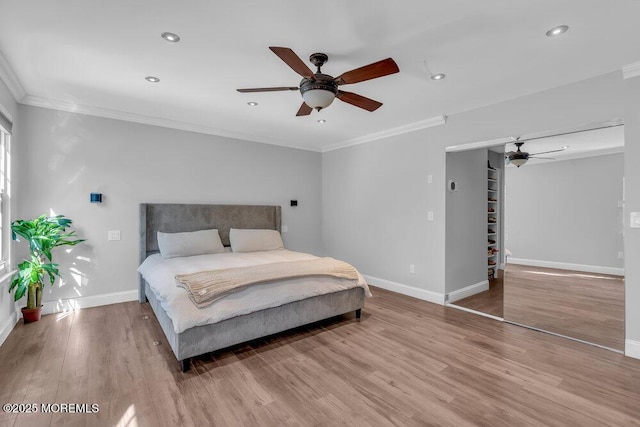 bedroom featuring crown molding, recessed lighting, wood finished floors, and baseboards