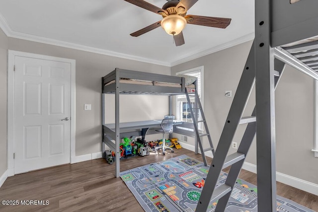 bedroom featuring crown molding, baseboards, and wood finished floors