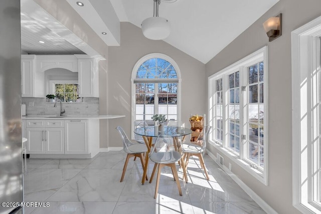 dining area with recessed lighting, marble finish floor, baseboards, and lofted ceiling