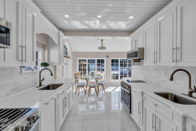 kitchen featuring wood ceiling, white cabinets, black appliances, and a sink