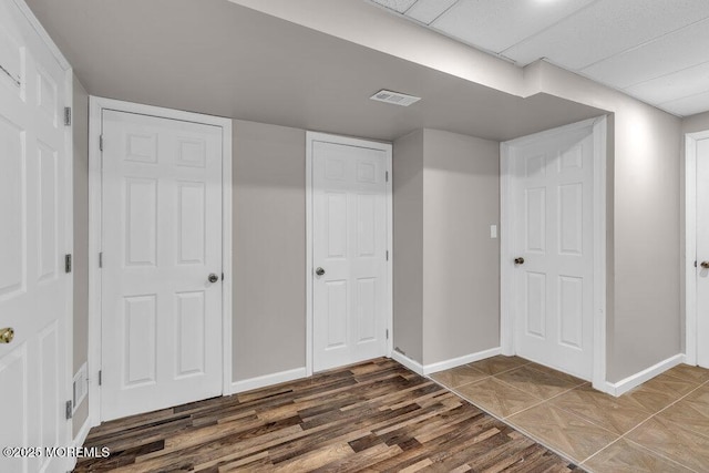 interior space with visible vents, baseboards, and wood finished floors