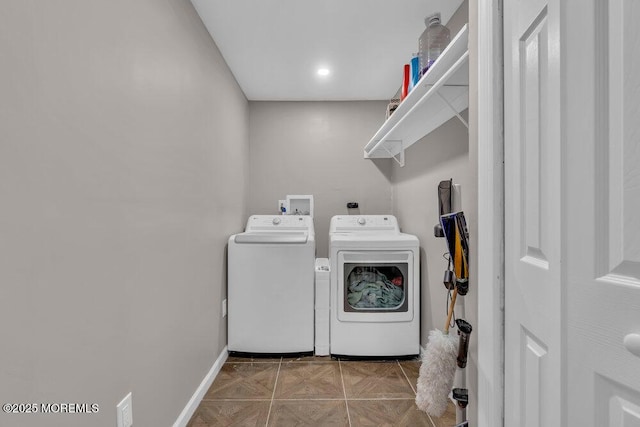 washroom with baseboards, washing machine and dryer, laundry area, and tile patterned flooring