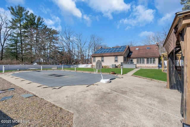 view of swimming pool featuring a lawn, a patio, a fenced in pool, and fence