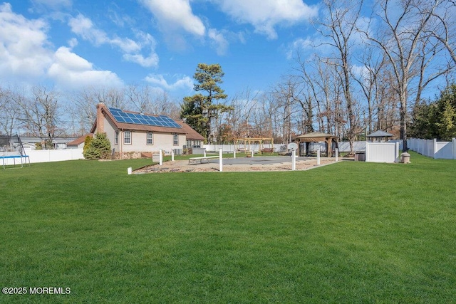 view of yard featuring a gazebo, a trampoline, and fence