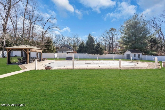 view of yard with a gazebo, a patio, an outdoor structure, and a fenced backyard