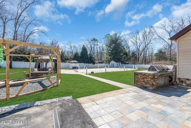 exterior space featuring an outbuilding, area for grilling, a fenced backyard, a playground, and a patio area