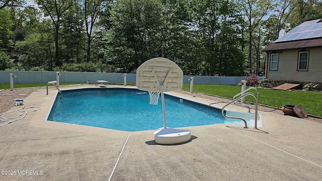 view of swimming pool featuring a fenced in pool, a lawn, a fenced backyard, and a patio area