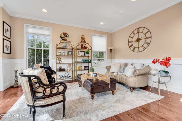 living area with recessed lighting, wainscoting, crown molding, and wood finished floors