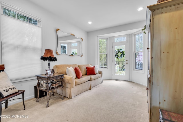 living room with light carpet, baseboards, and recessed lighting