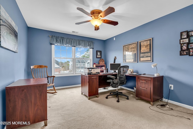 office area featuring light colored carpet, visible vents, ceiling fan, and baseboards