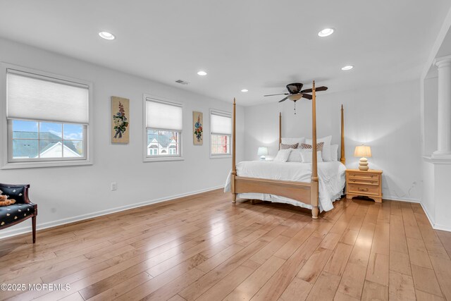 bedroom featuring recessed lighting, visible vents, decorative columns, and light wood-style flooring