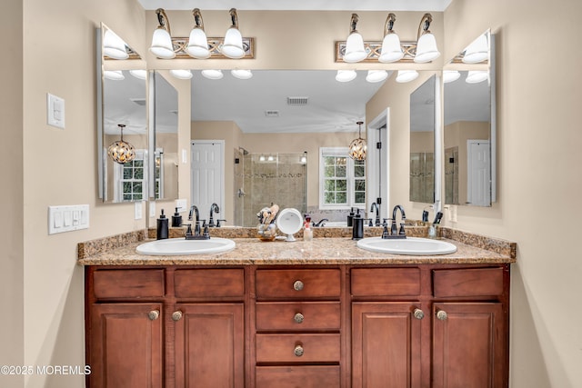 full bathroom featuring visible vents, a sink, a shower stall, and double vanity