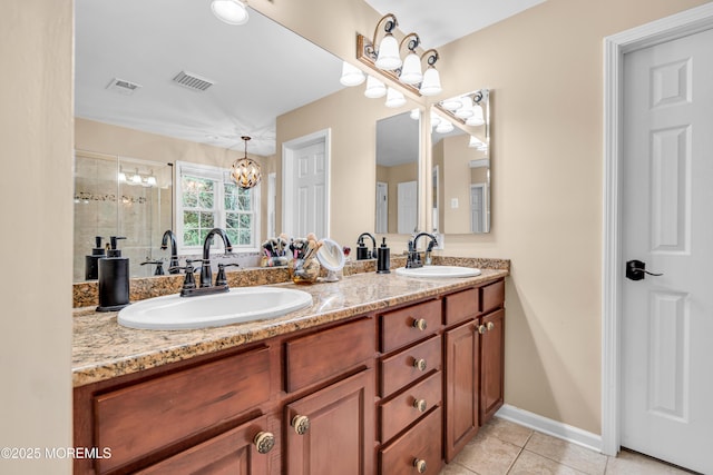 bathroom with double vanity, visible vents, a sink, and tile patterned floors