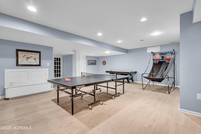 recreation room with baseboards, ornate columns, recessed lighting, and light wood-style floors