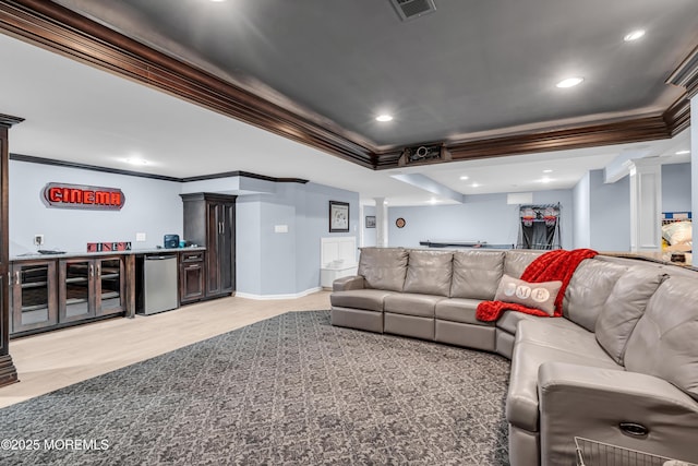 living area featuring crown molding, visible vents, decorative columns, and a dry bar