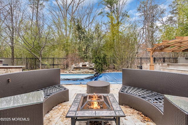 view of patio / terrace with a fenced in pool, an outdoor fire pit, a fenced backyard, and a pergola