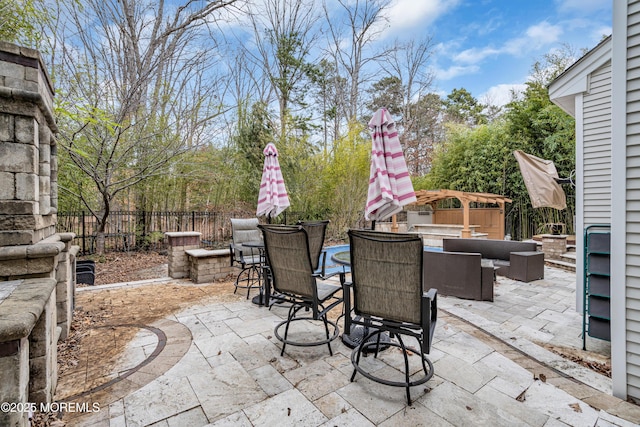 view of patio / terrace featuring an outdoor hangout area, outdoor dining space, and fence