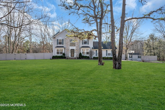 view of front of home with fence and a front yard