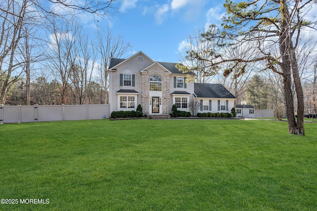 view of front of property featuring fence and a front yard