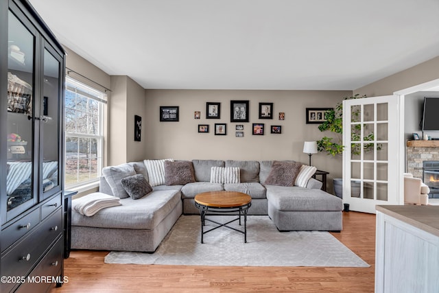 living area featuring a fireplace and light wood-style flooring