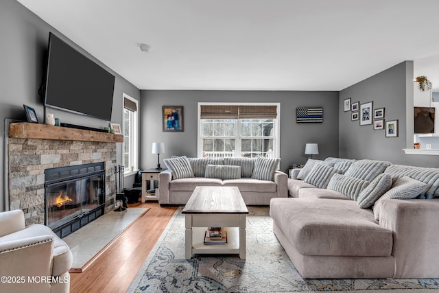 living room with light wood-type flooring and a fireplace