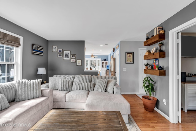 living room with light wood-type flooring, ceiling fan, baseboards, and recessed lighting