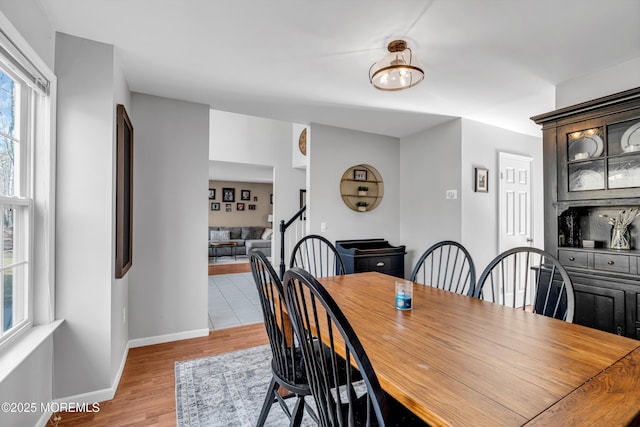 dining room with light wood-type flooring and baseboards