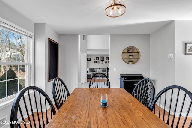 dining space with wood finished floors and baseboards