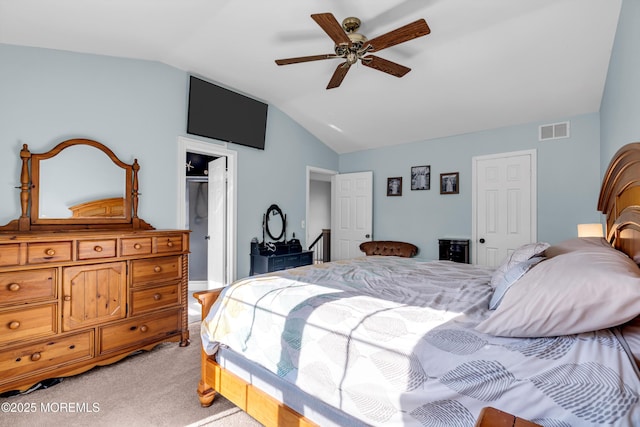 bedroom with visible vents, vaulted ceiling, a ceiling fan, and light colored carpet