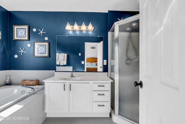 ensuite bathroom featuring a stall shower, vanity, ensuite bathroom, and a bath