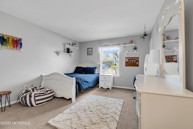 bedroom with light colored carpet and baseboards