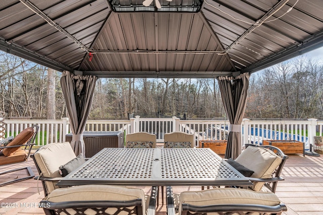 deck featuring a gazebo and outdoor dining area