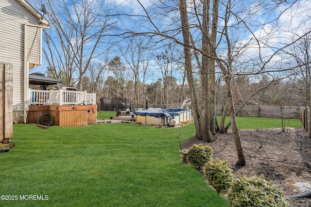 view of yard with a fenced in pool, a fenced backyard, and a deck