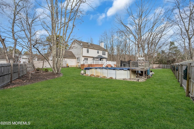 view of yard featuring a fenced backyard, a fenced in pool, and a wooden deck