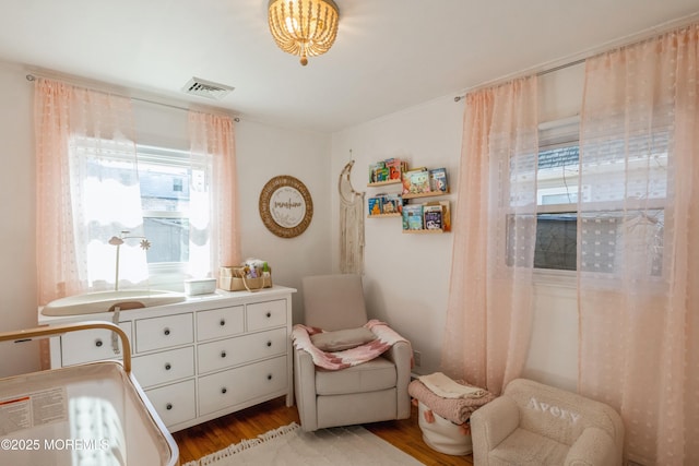 bedroom with light wood-style flooring and visible vents