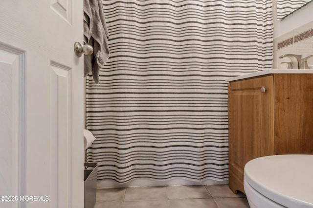 full bathroom featuring tile patterned flooring, vanity, and toilet