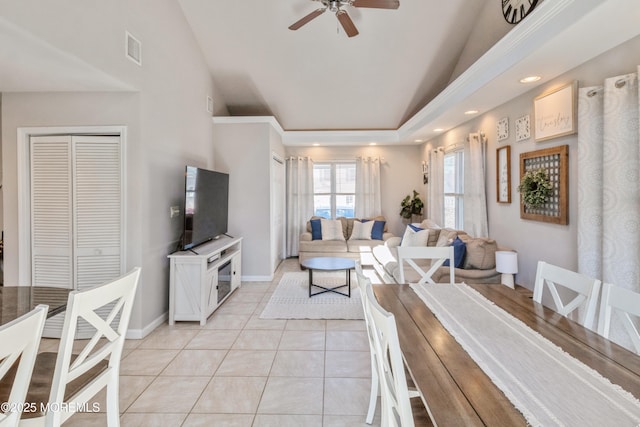 dining room with light tile patterned floors, ceiling fan, vaulted ceiling, and visible vents